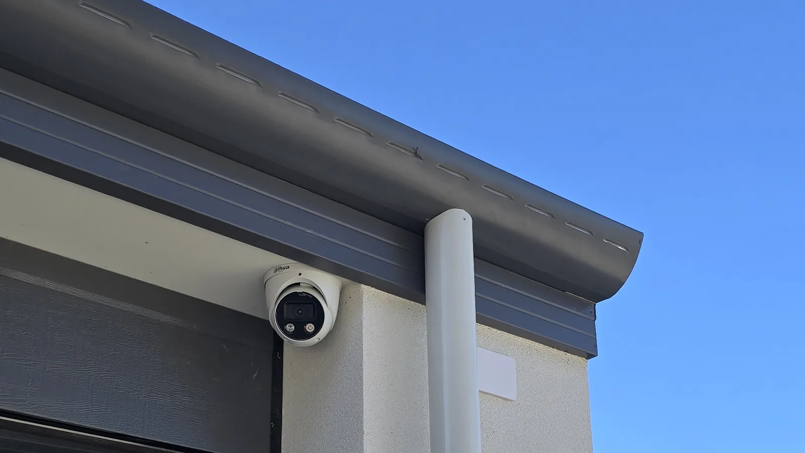 Dahua CCTV camera repositioned away from a pre-wire point beside a garage downpipe
